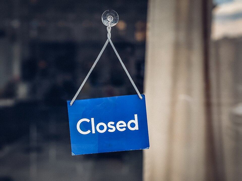 Closed sign hanging in a shop door
