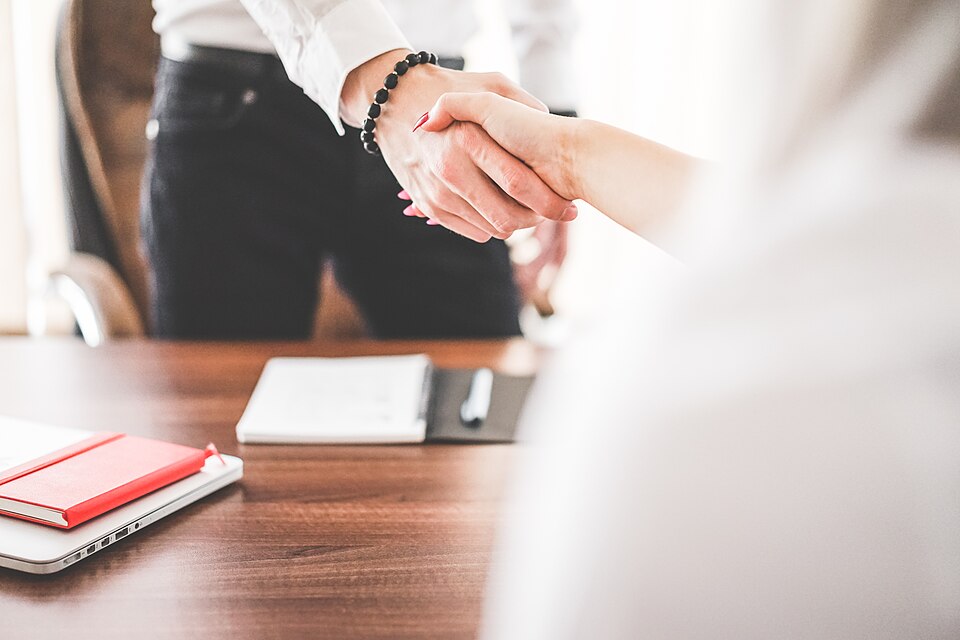 Business handshake in an office